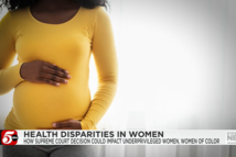 A Black woman holding her pregnant belly, via ABC 5 KSTP