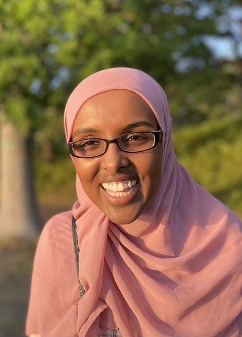 Roon Makhtal, a laughing Black/Somali Muslim woman.